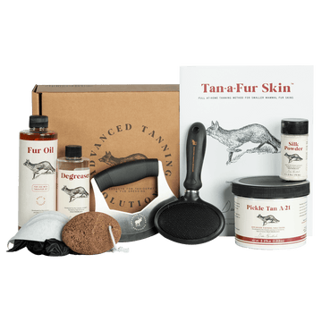 Advanced Tanning Solutions Tan-A-Fur Skin kit including Fur Oil, Degreaser, Pickle Tan A-21, Silk Powder, and fleshing tool. 